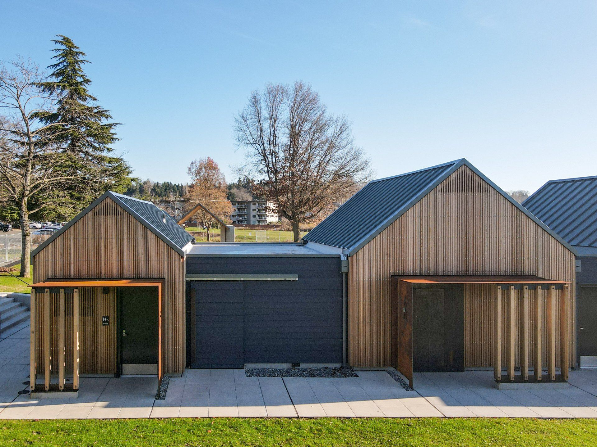 A row of houses with wooden siding and a metal roof