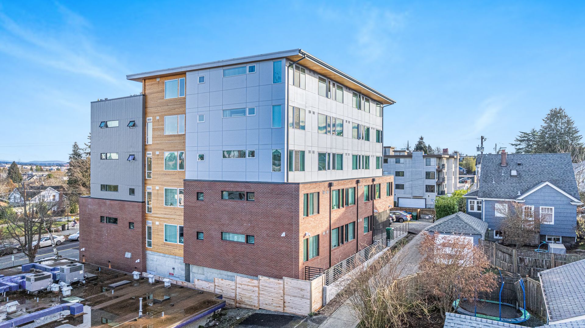 An aerial view of a large apartment building in a city.