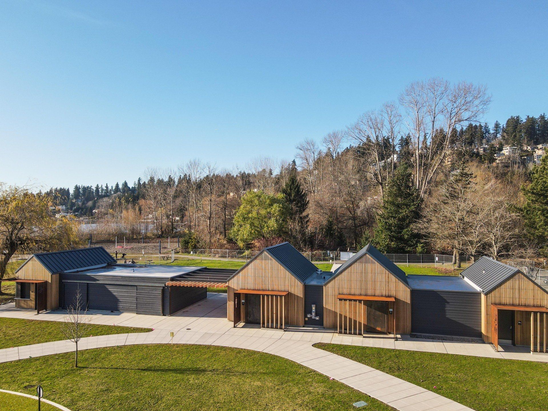 A row of houses are sitting next to each other on a lush green field.