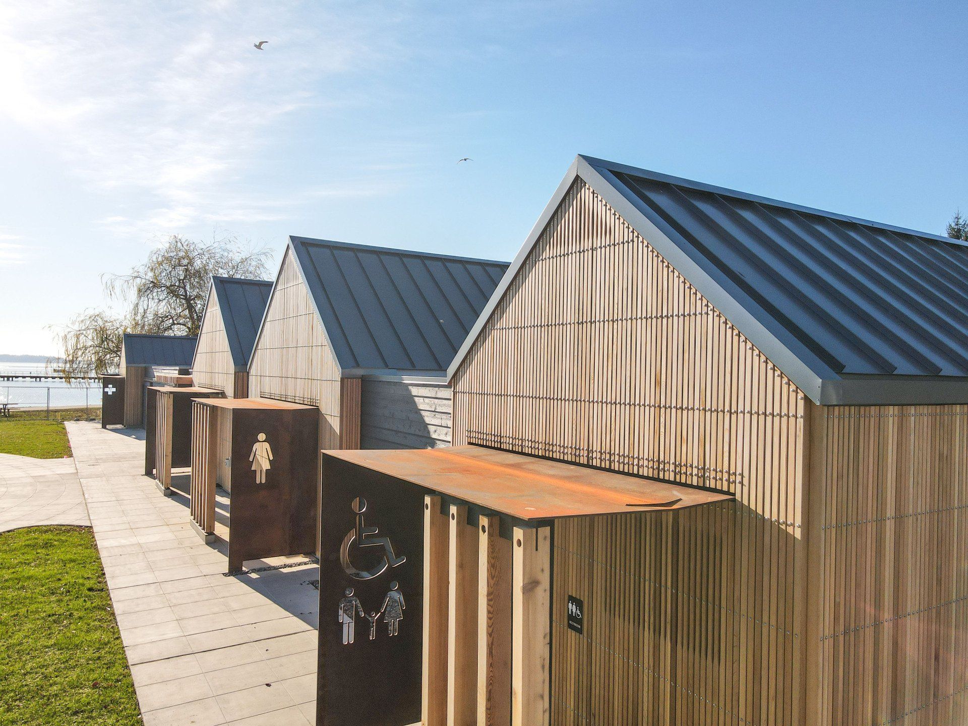 A row of wooden buildings with a metal roof