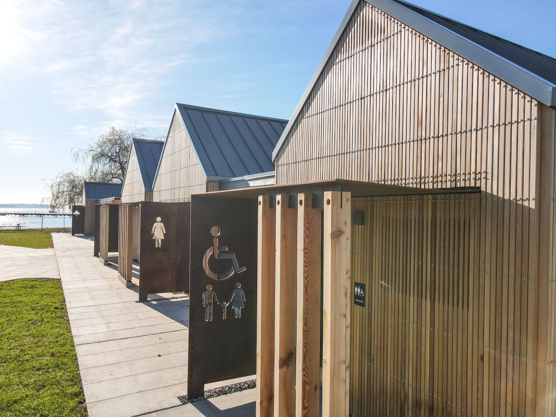 A row of wooden buildings with a handicap sign on the door