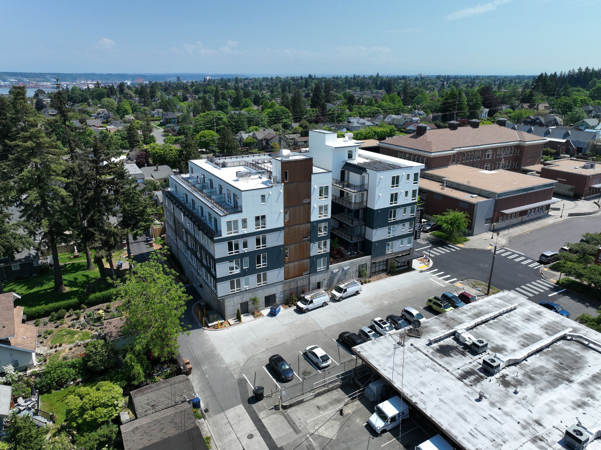 An aerial view of a building with cars parked in front of it