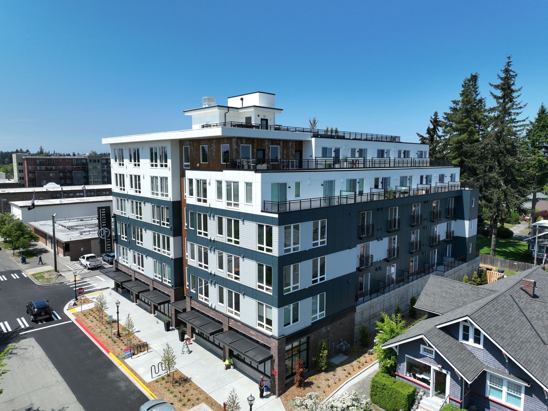 An aerial view of a large apartment building surrounded by houses.