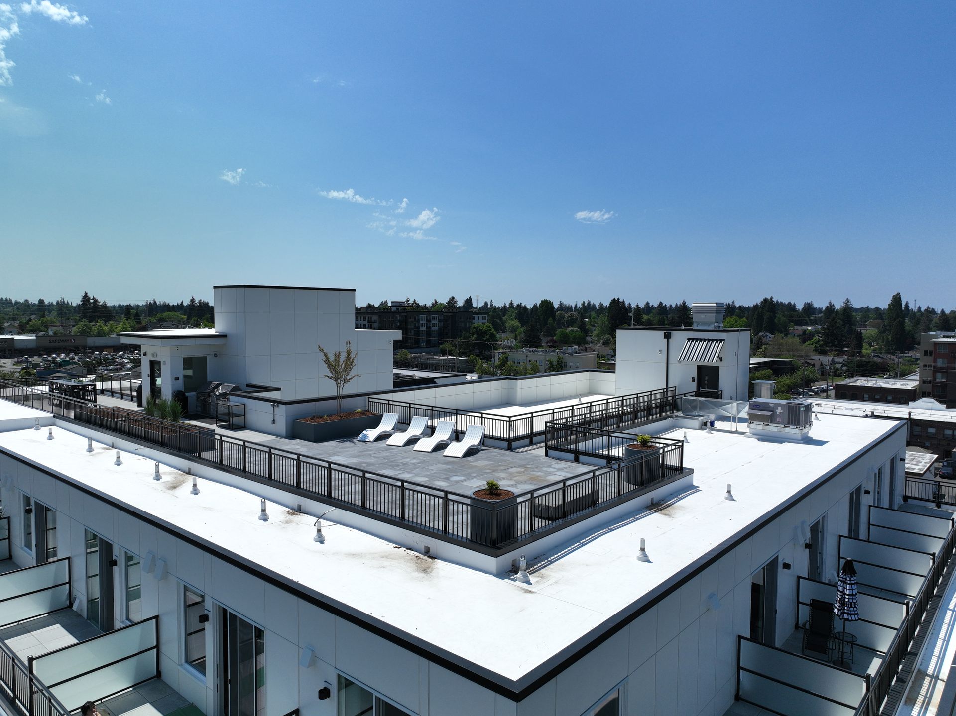 An aerial view of a building with a white roof