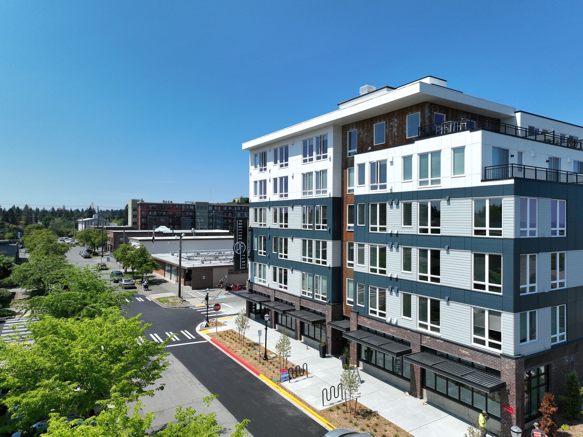 An aerial view of a large building with lots of windows in a city.