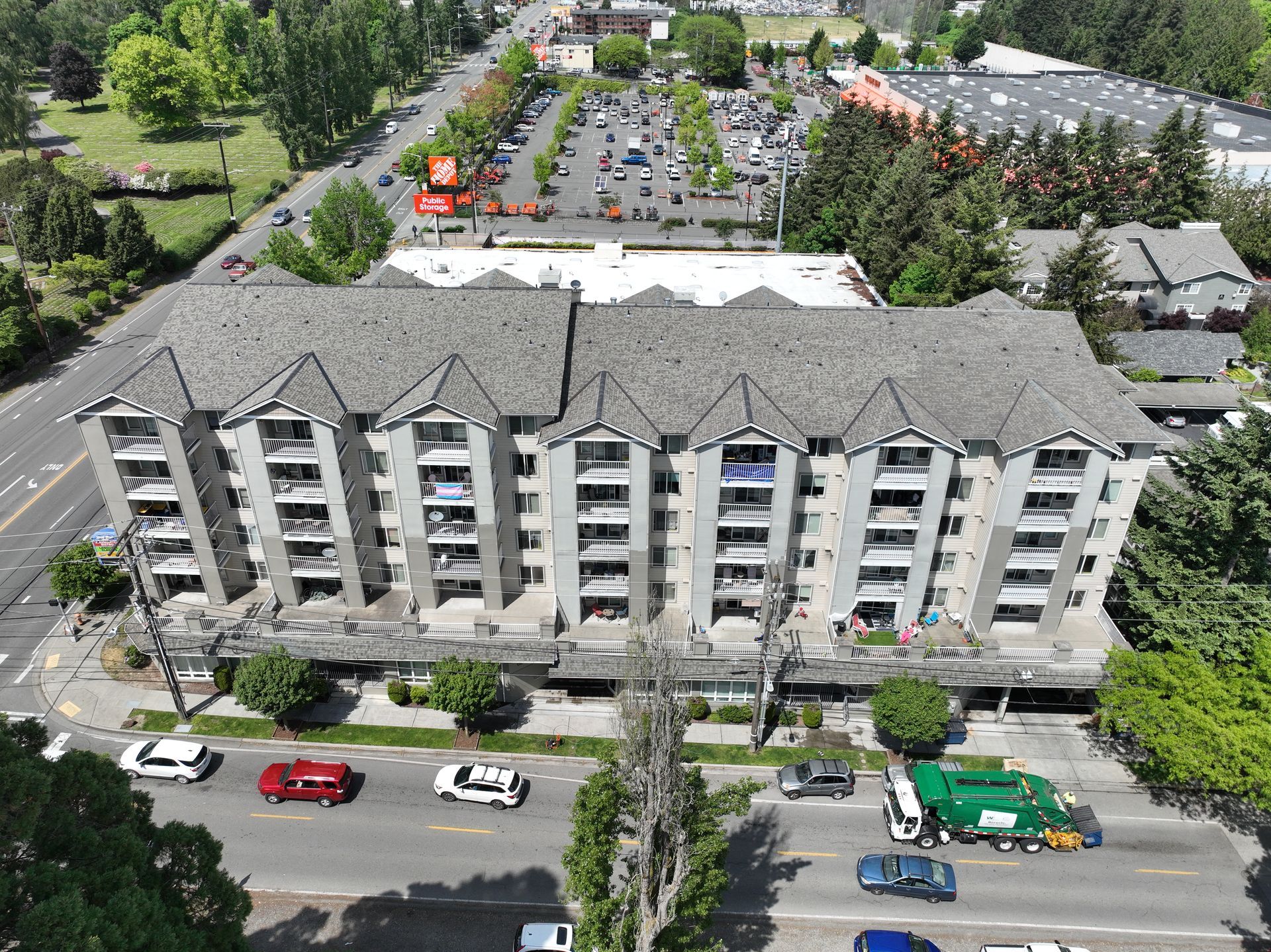 An aerial view of a building with a lot of cars parked in front of it