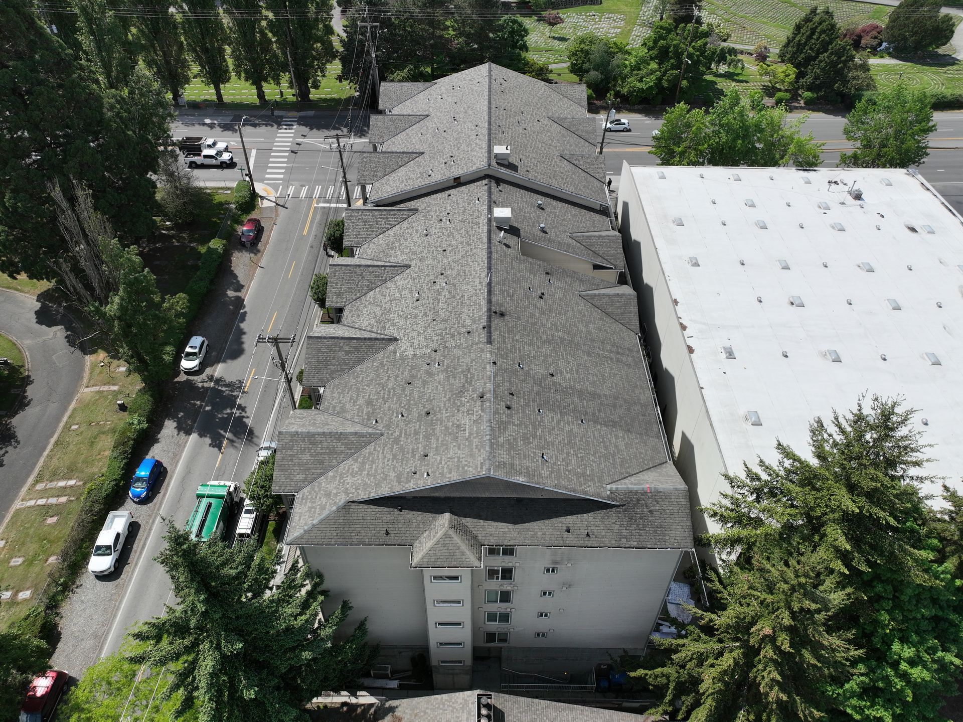 An aerial view of a building with a white roof