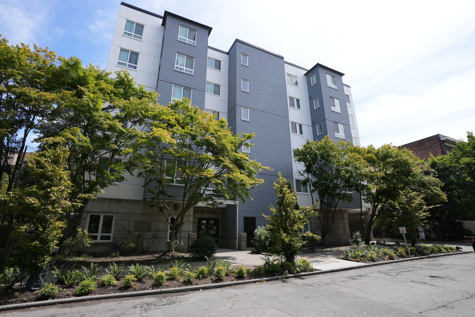 A large building with a lot of windows and trees in front of it