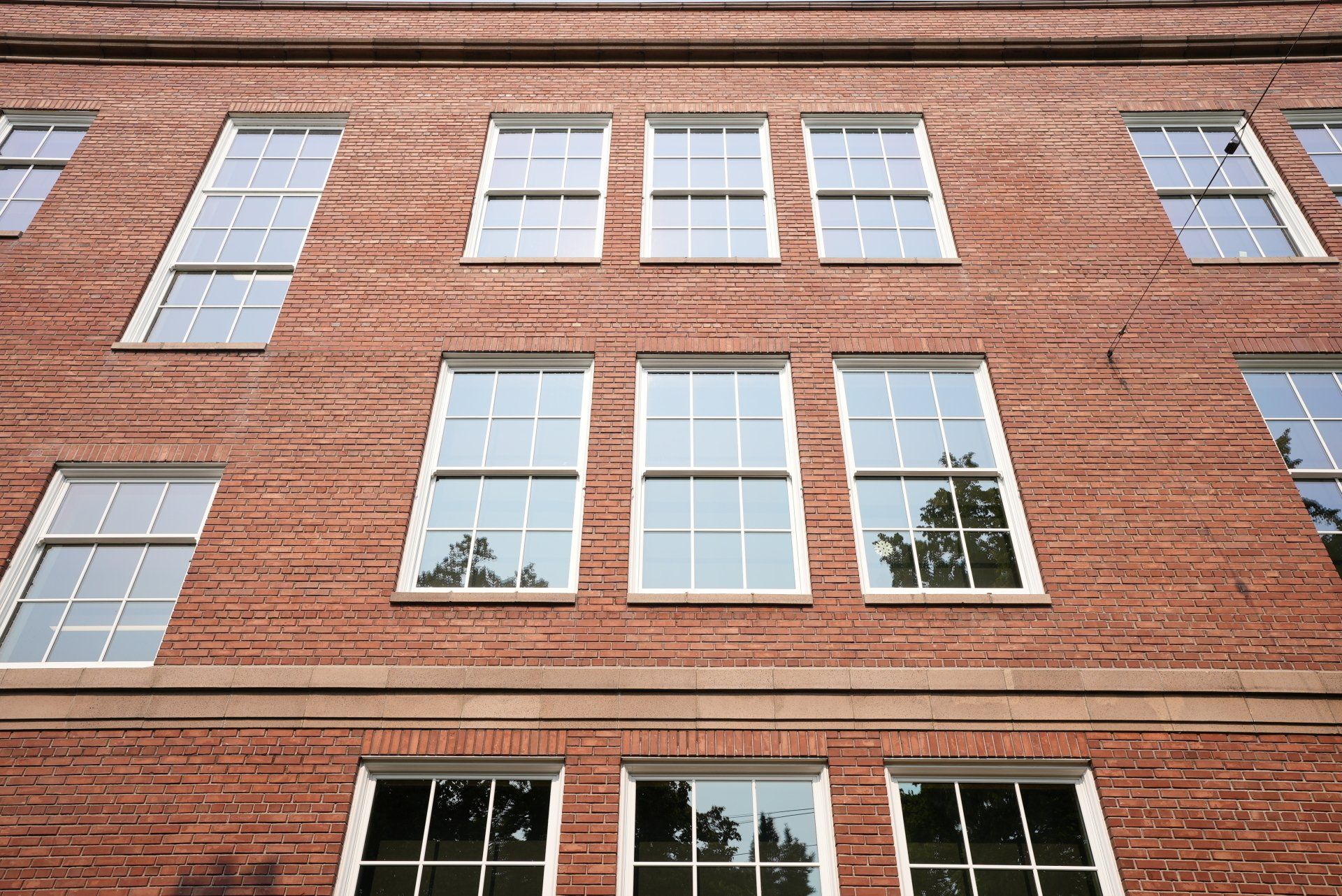 A brick building with a lot of windows on it