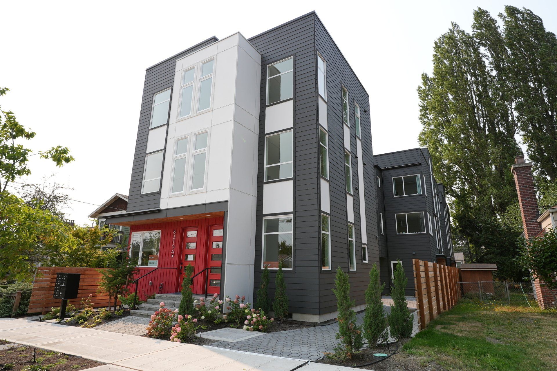 A large building with a lot of windows and a red door