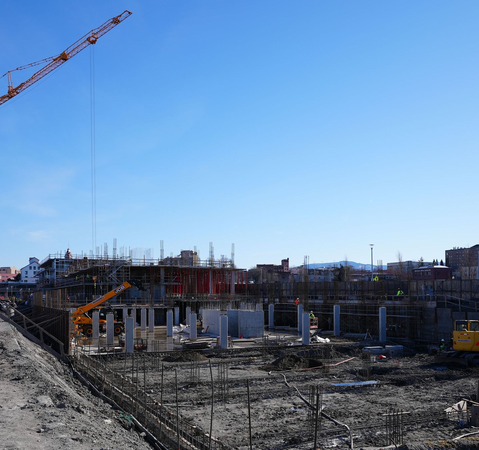 A large construction site with a crane in the foreground