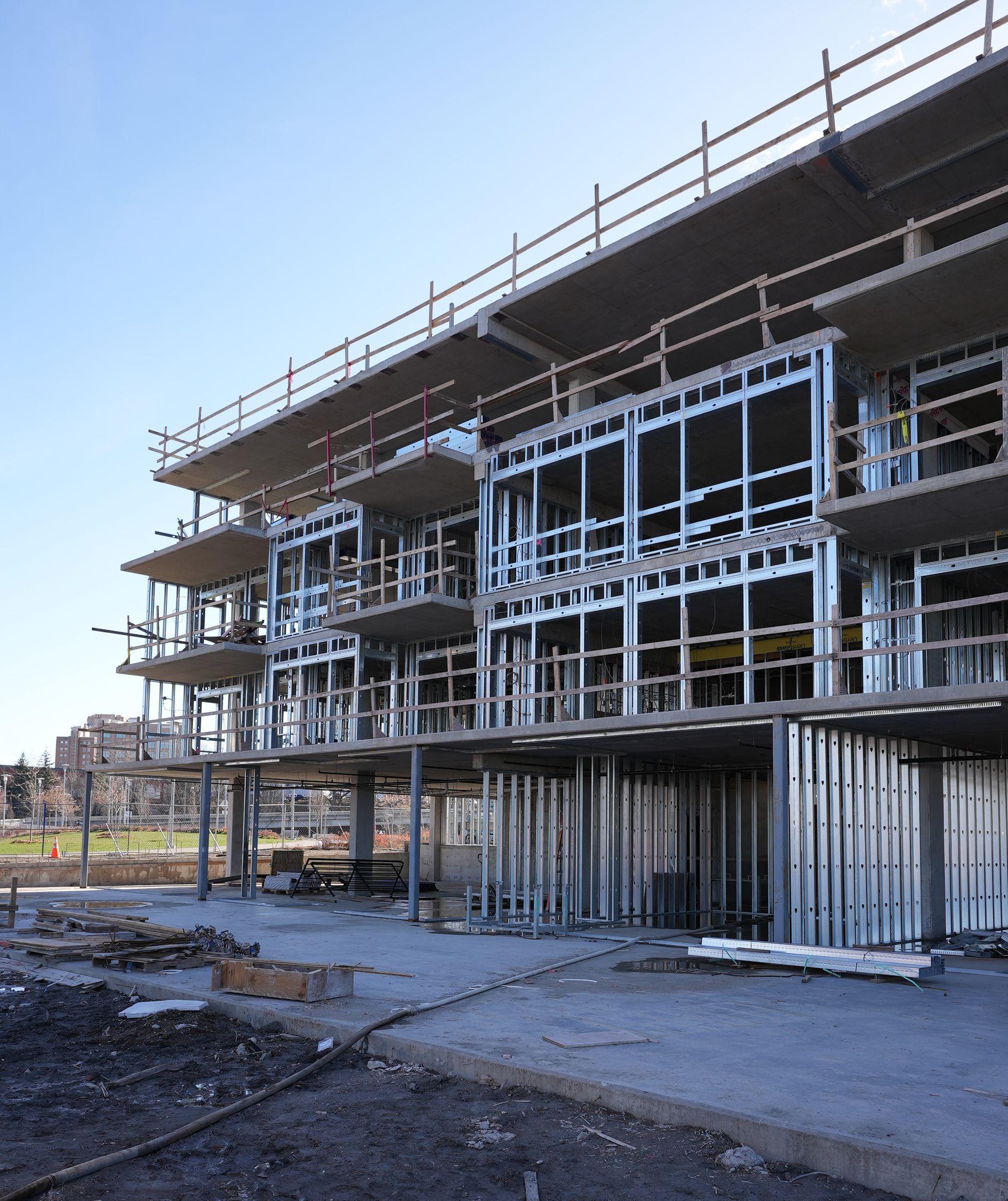 A large building under construction with a blue sky in the background