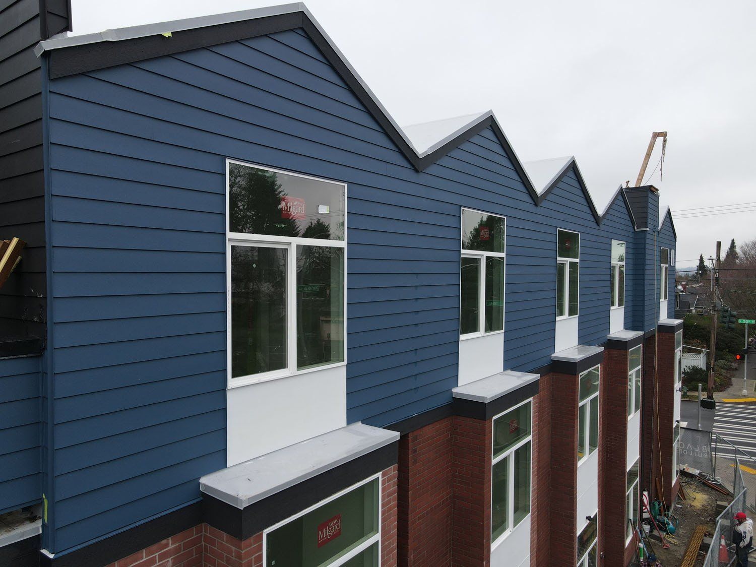 A building with blue siding and a row of windows