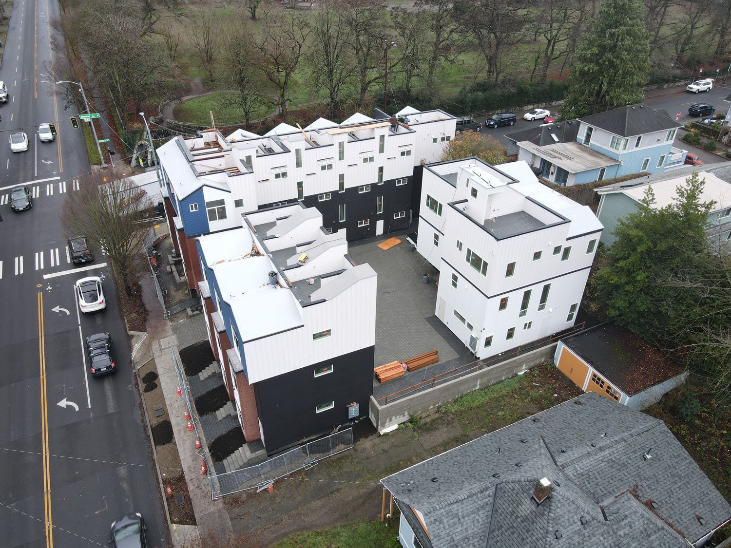 An aerial view of a row of buildings next to a street