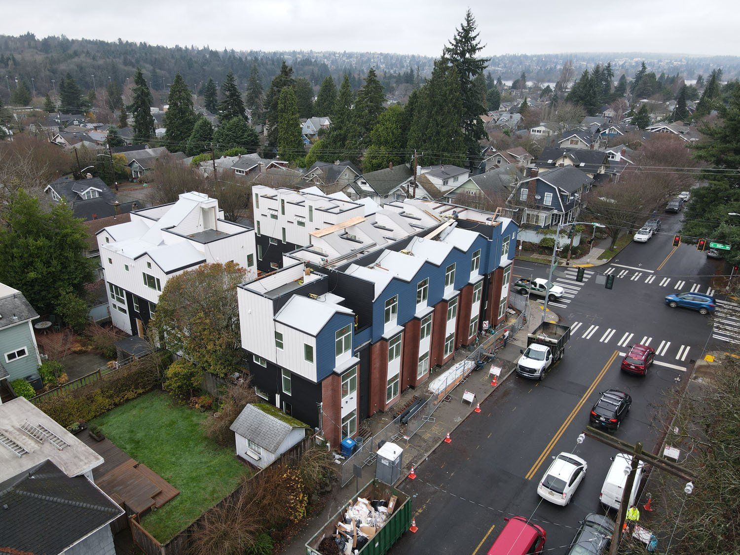 An aerial view of a building under construction in a residential area.