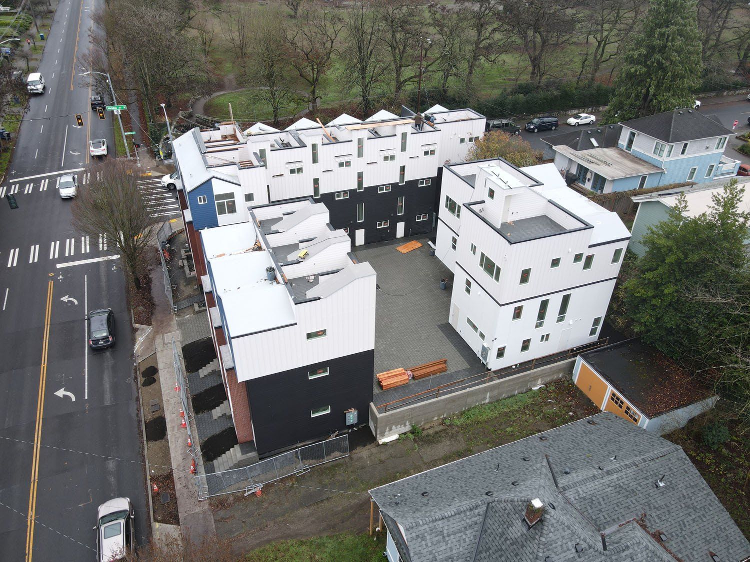 An aerial view of a building under construction next to a road