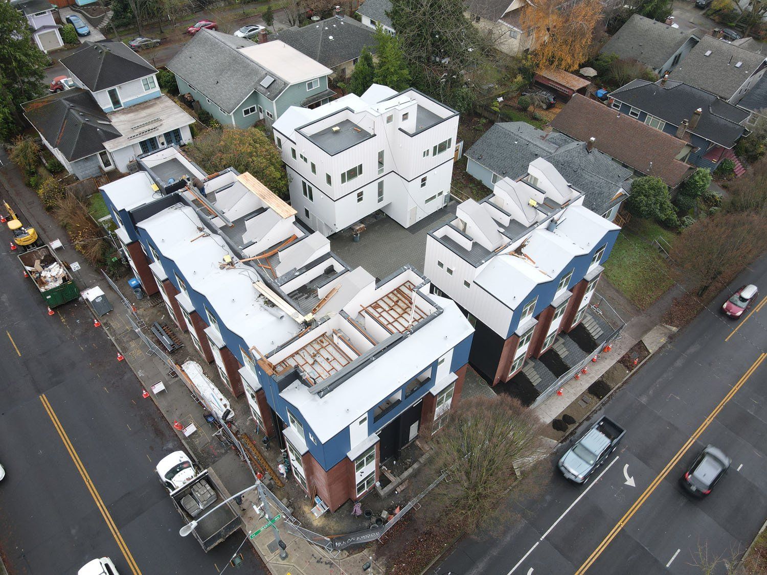 An aerial view of a building under construction in a residential area