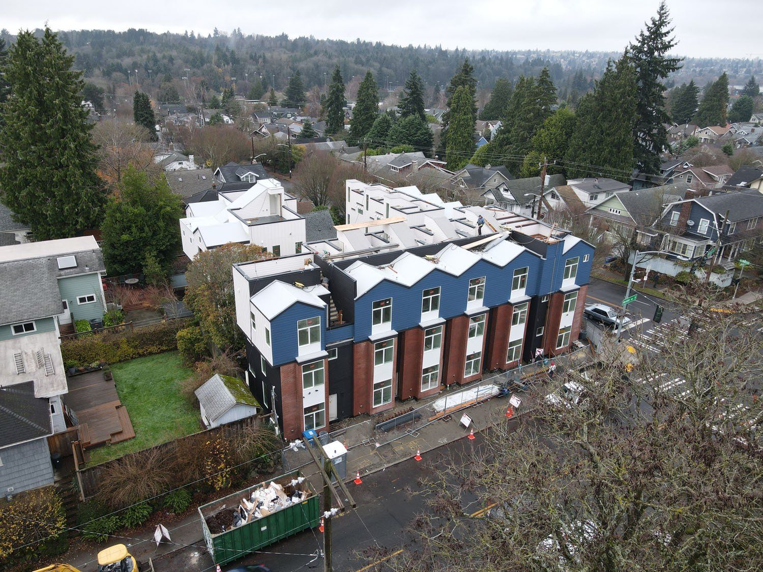 An aerial view of a building under construction in a residential area