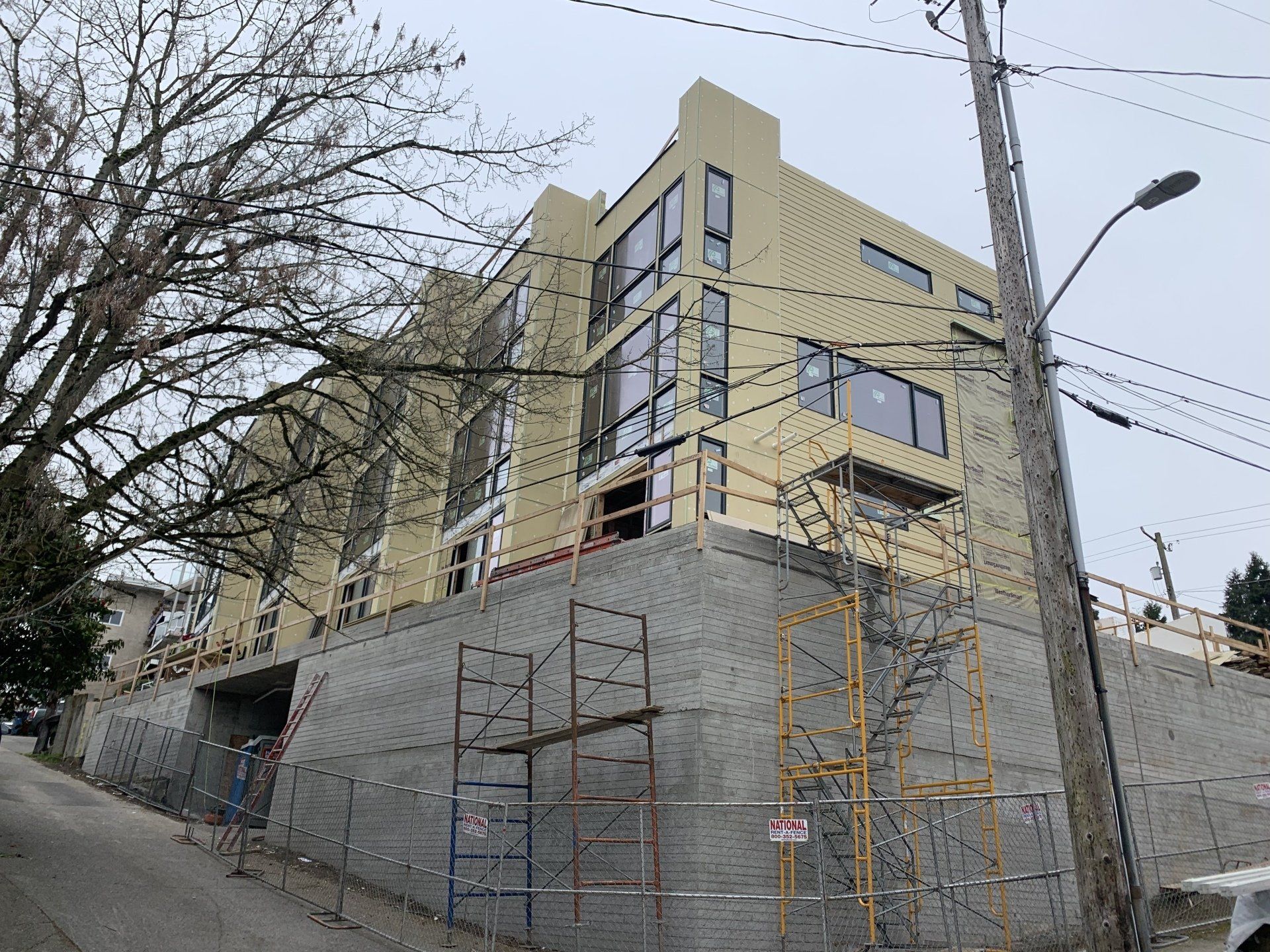 A large building is being built on top of a hill.