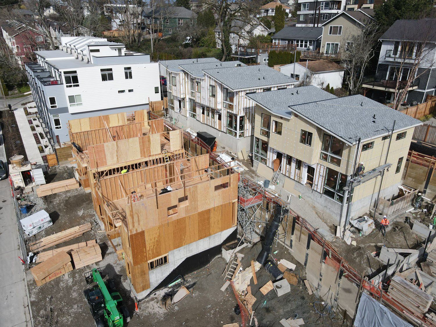 An aerial view of a building under construction in a city.