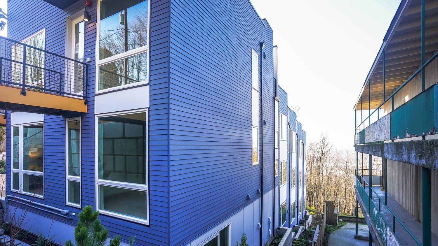 A blue building with a lot of windows and balconies