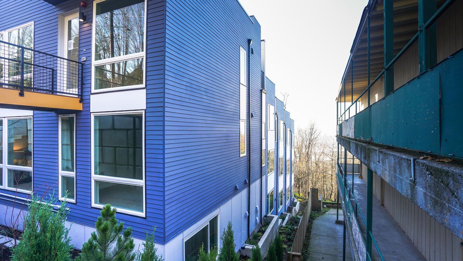 A blue building with a lot of windows and balconies