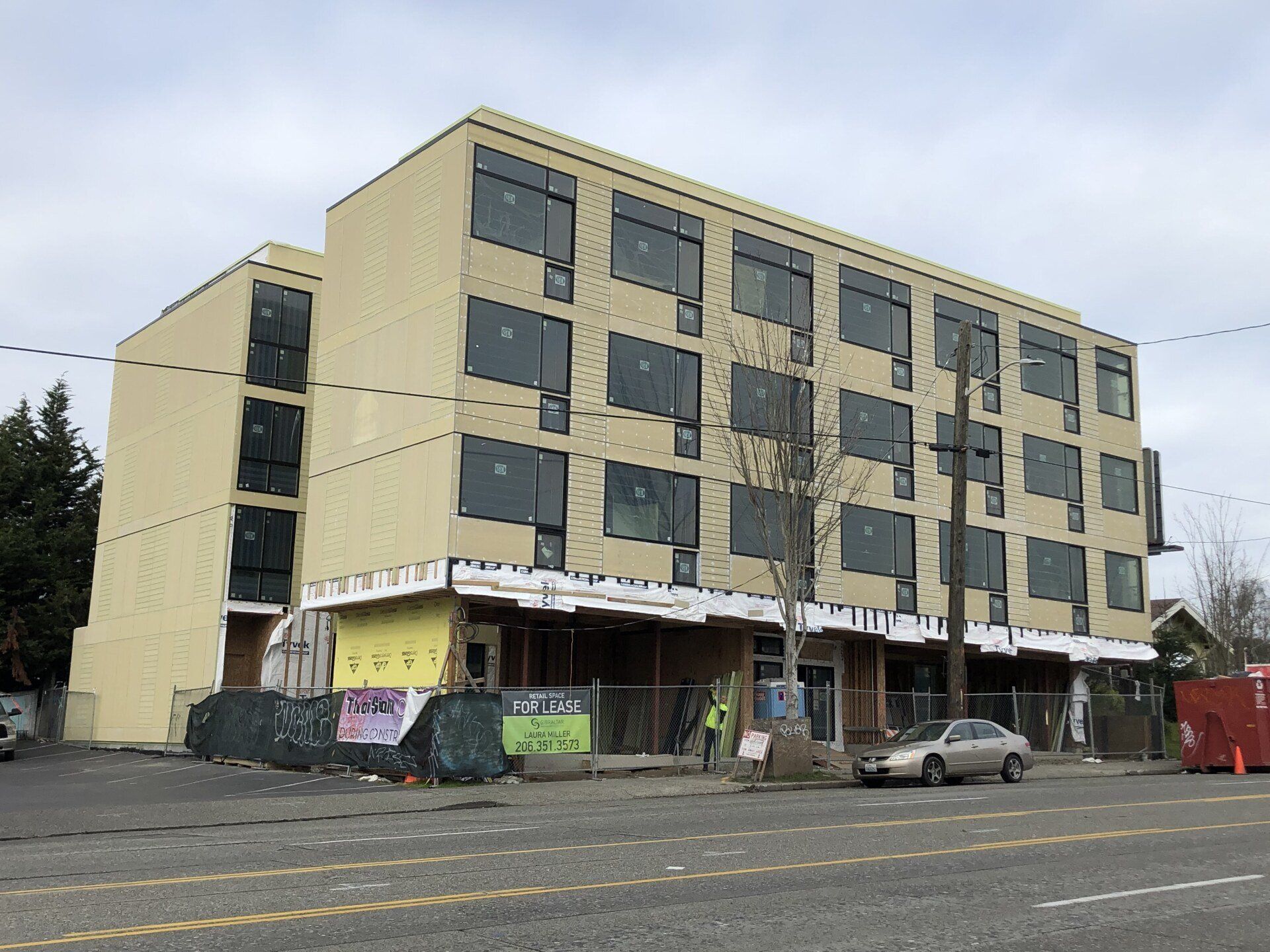 A large building with a lot of windows is under construction.