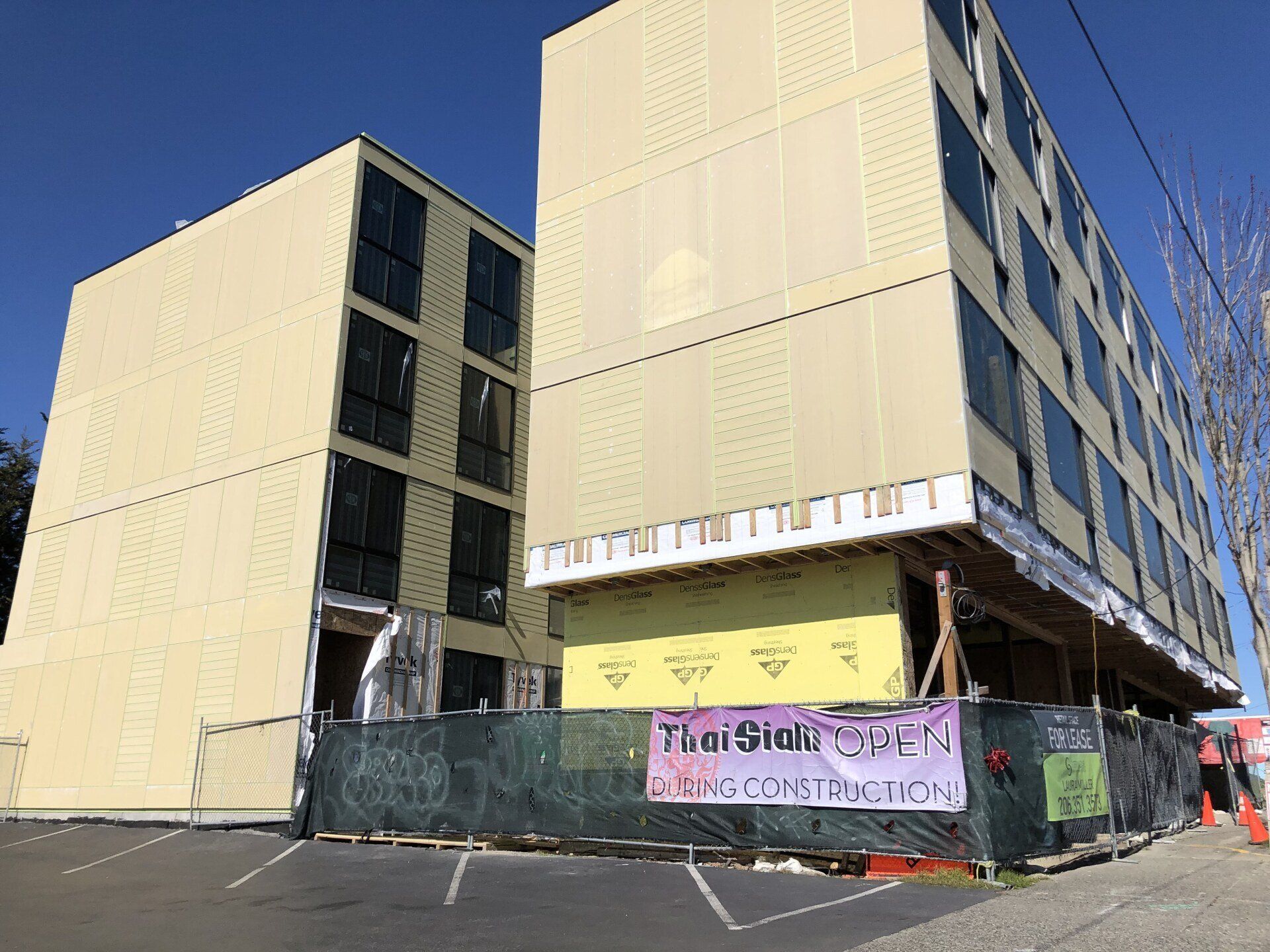 A large building under construction with a fence around it.