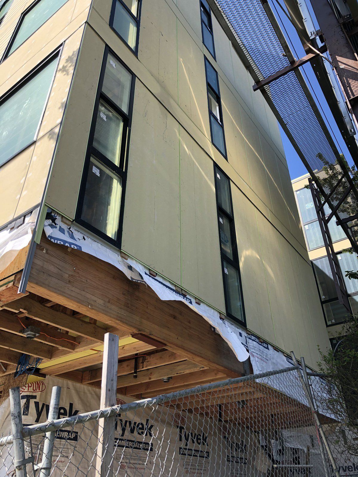 A building under construction with a fence around it.