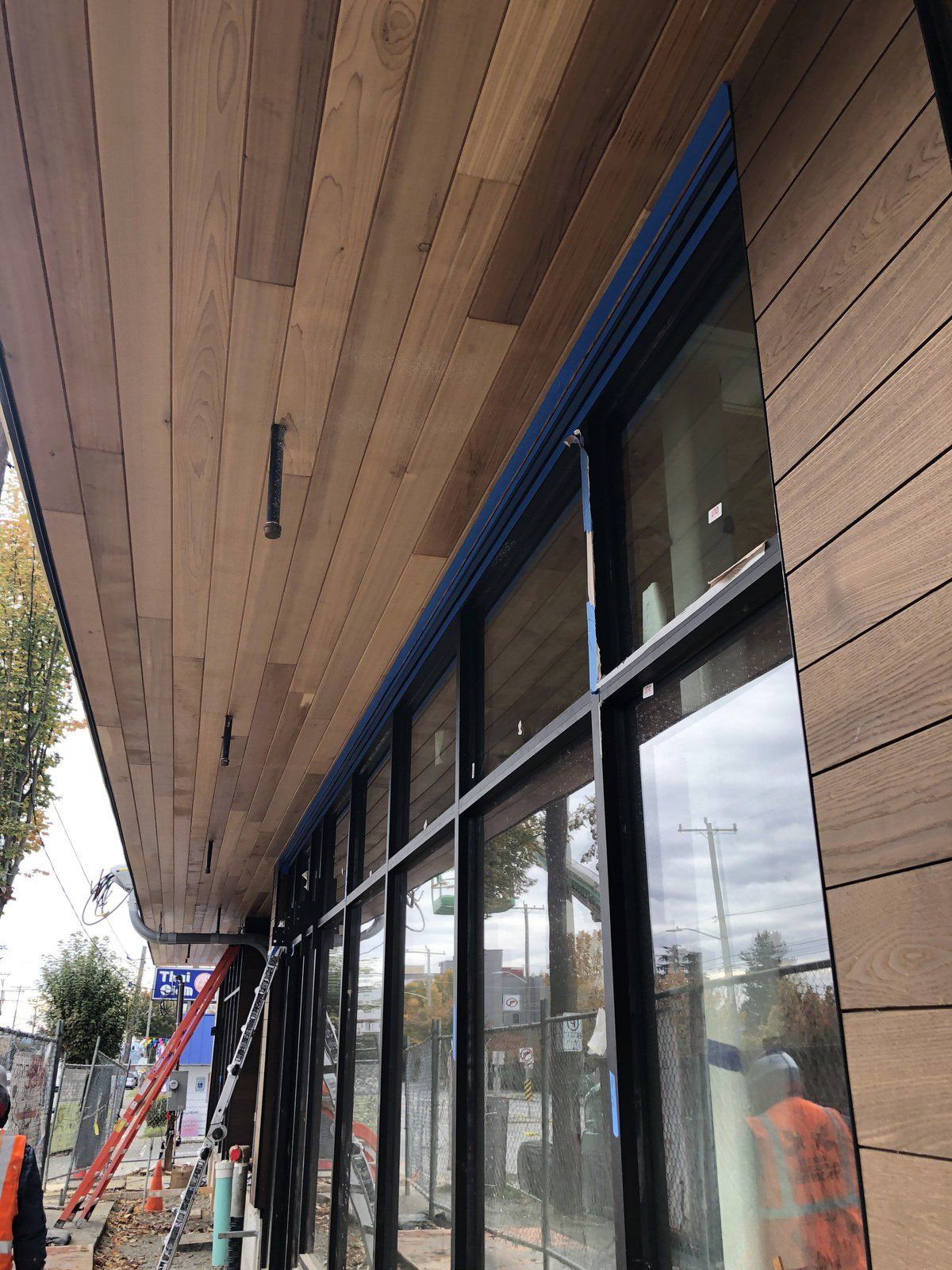 A building under construction with a lot of windows and a wooden ceiling.