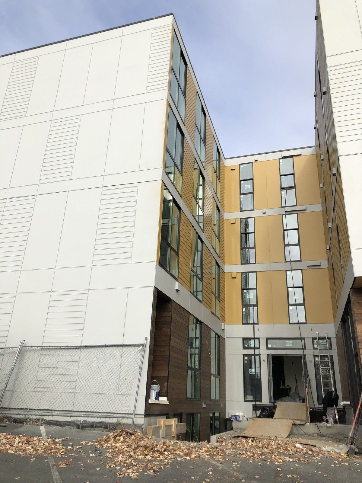 A large building with a lot of windows is under construction.