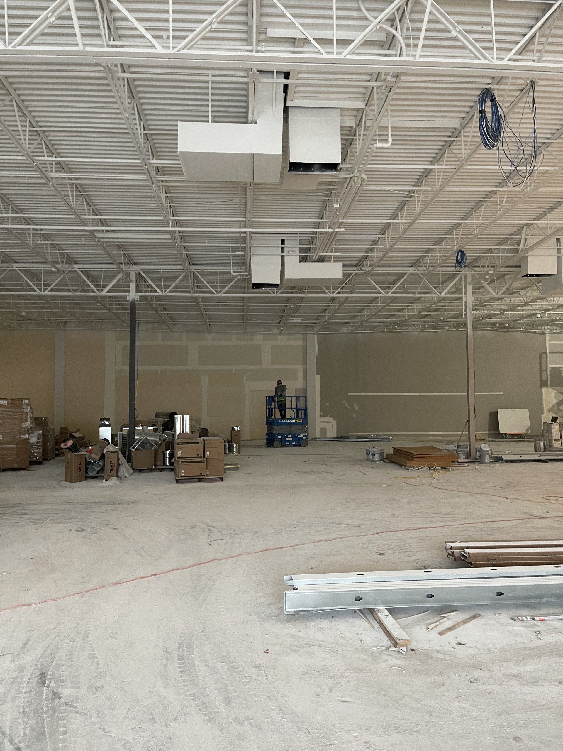 A large building under construction with a lot of boxes on the floor