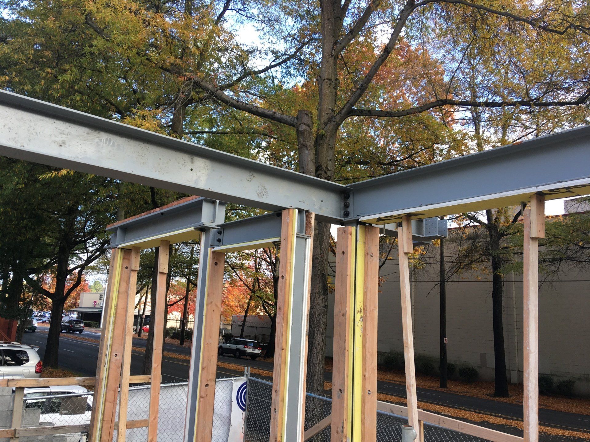 A building is being built in a city with trees in the background.