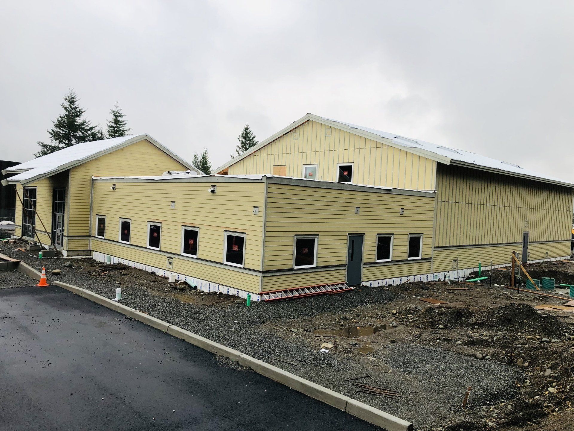 A large yellow building with a lot of windows is being built.