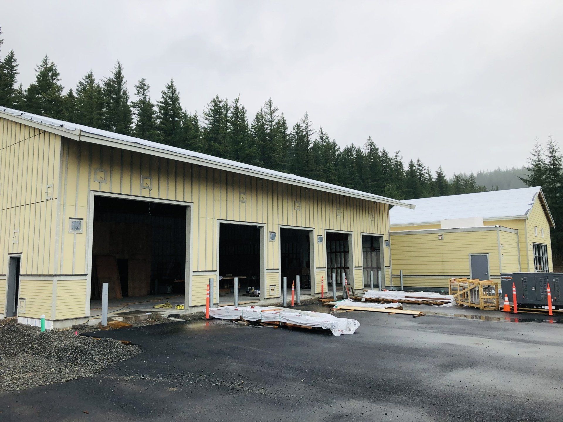 A large building with a lot of doors and trees in the background