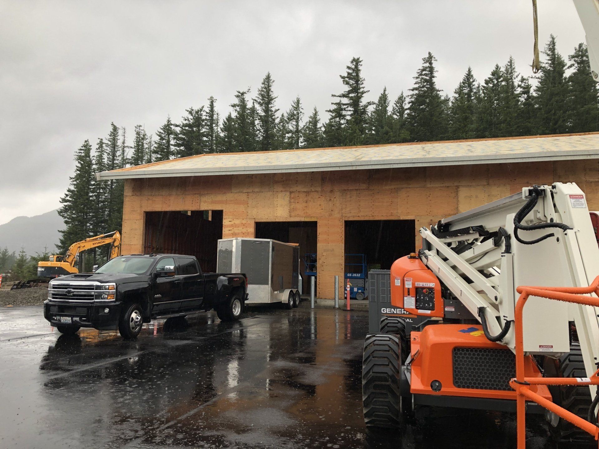 A truck is parked in front of a building under construction.