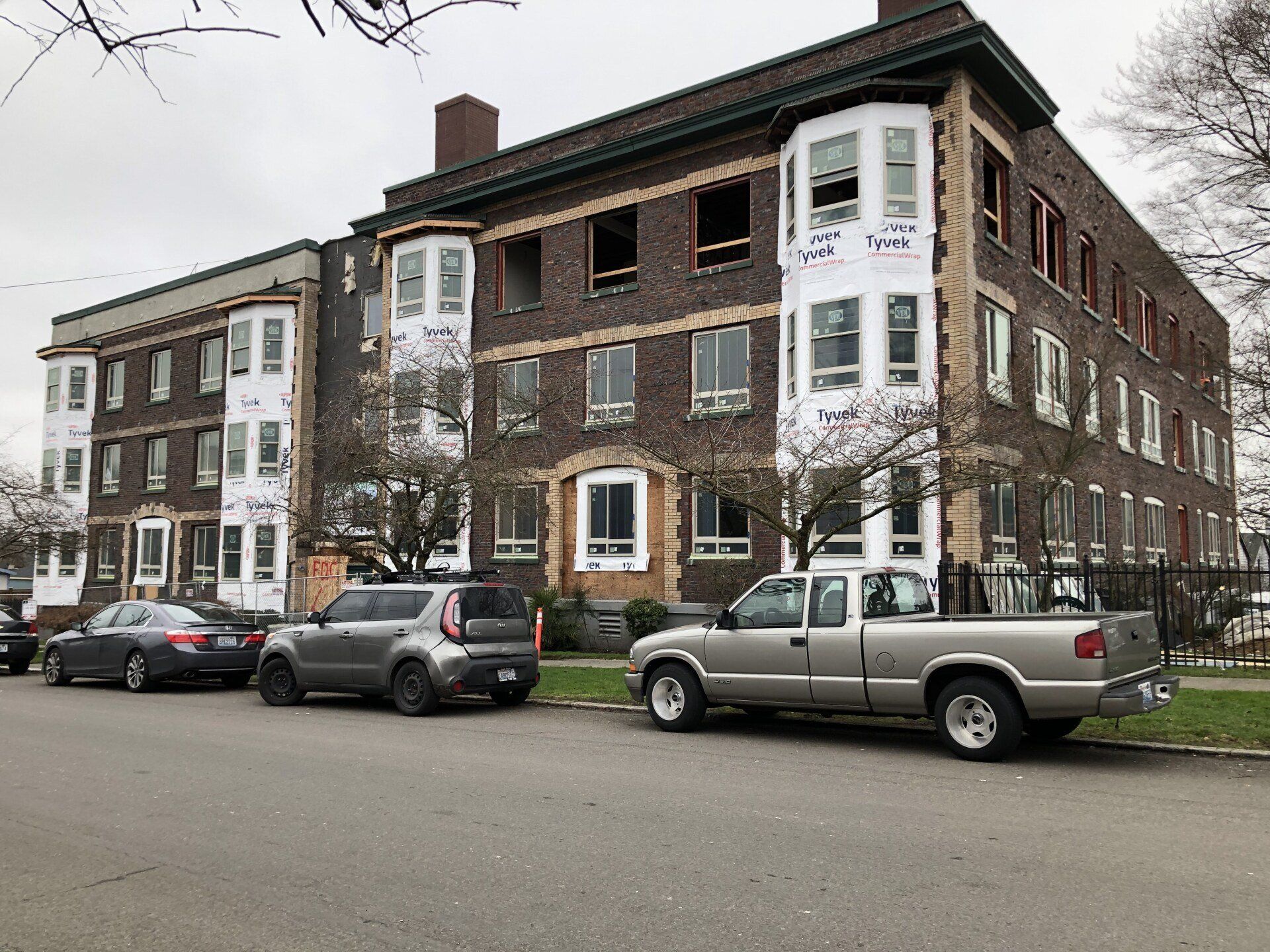 A large brick building with cars parked in front of it