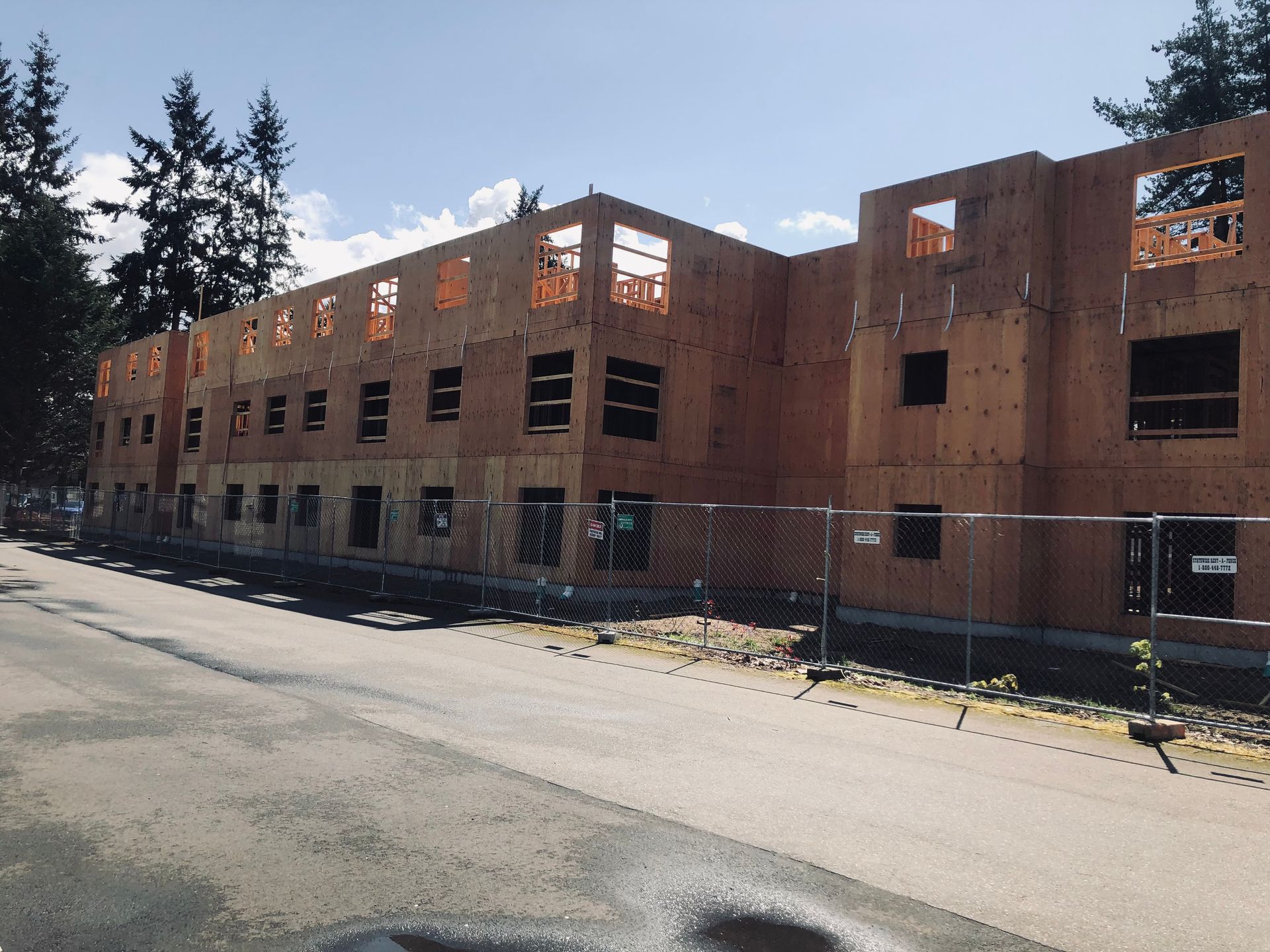 A large building under construction with a fence around it