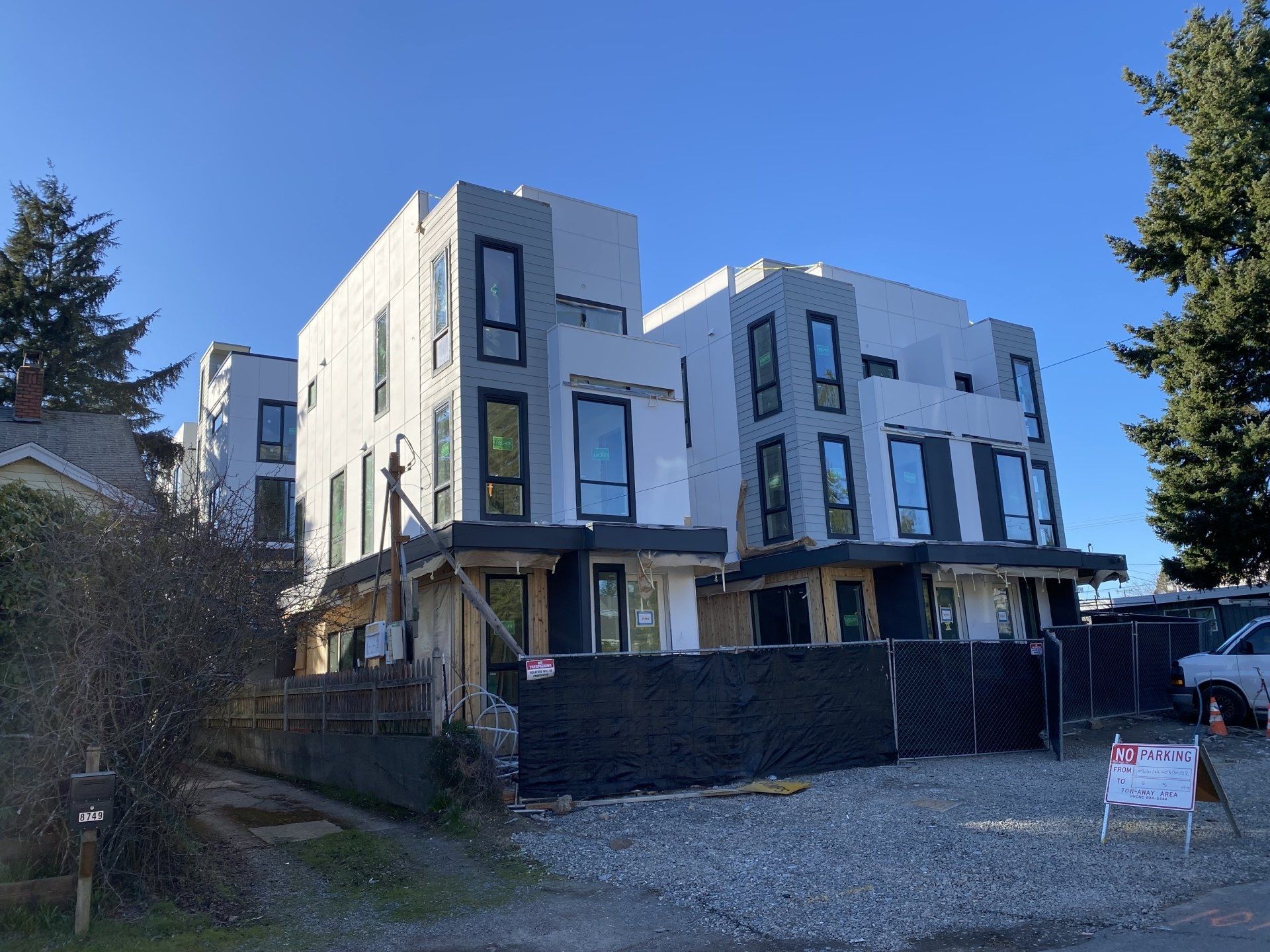 A large white building with a lot of windows is being built.