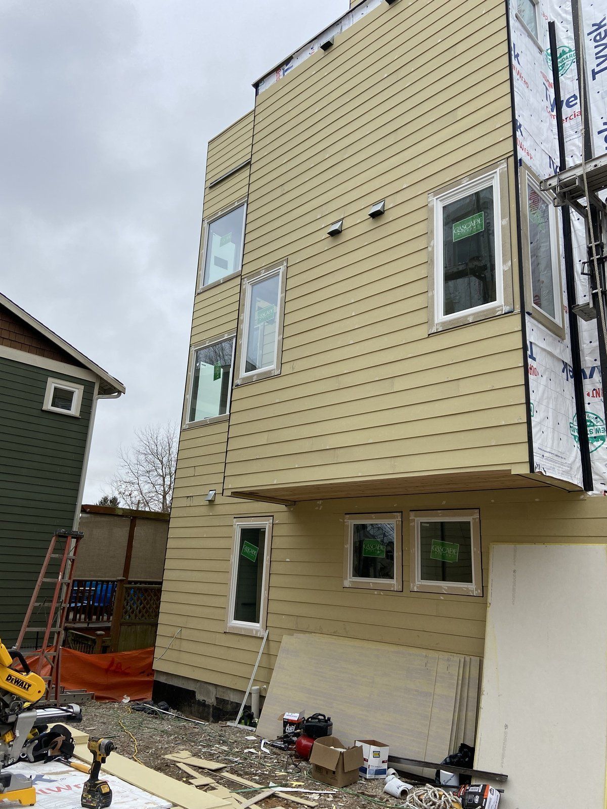 A building under construction with a lot of windows and siding.