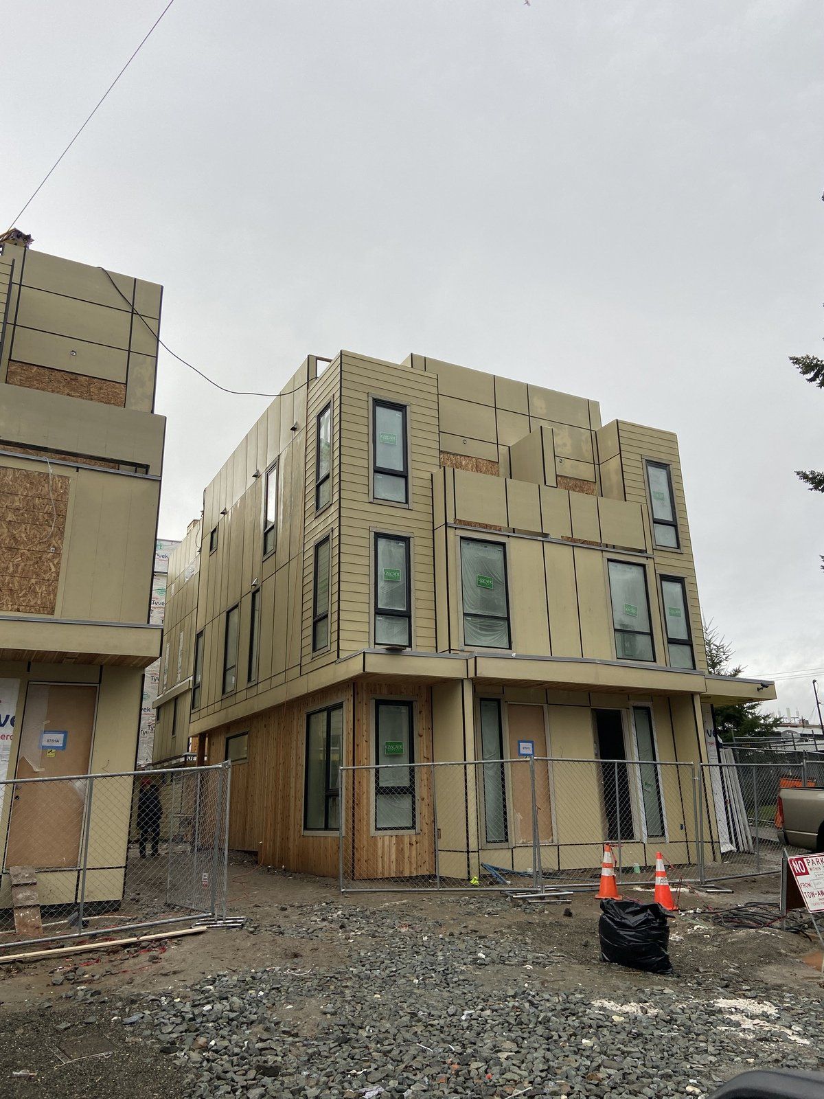 A building under construction with a lot of windows and a fence around it.