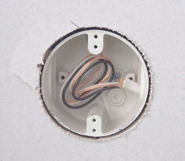 A white box with wires coming out of it.