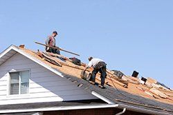 Roofers — Man Repairing The Roof in Columbus, OH