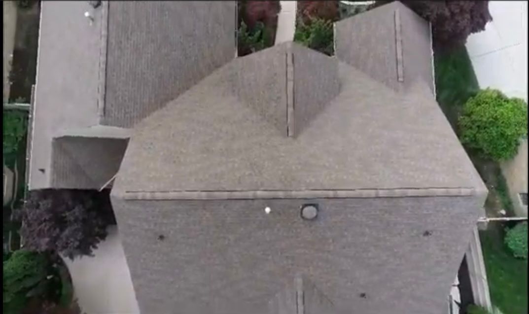 An aerial view of a house with a roof that looks like a castle.