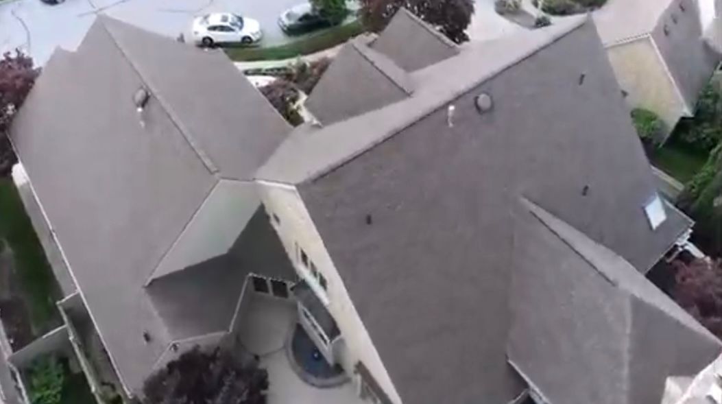 An aerial view of a house with a gray roof.