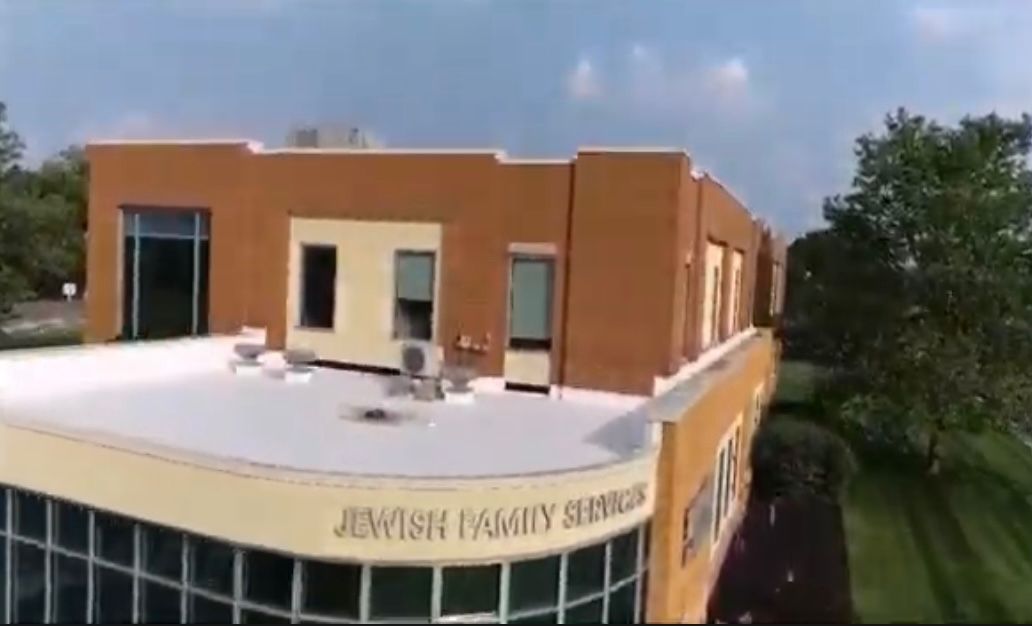 An aerial view of a building with a white roof.