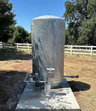A water pump with blue pipes attached to it