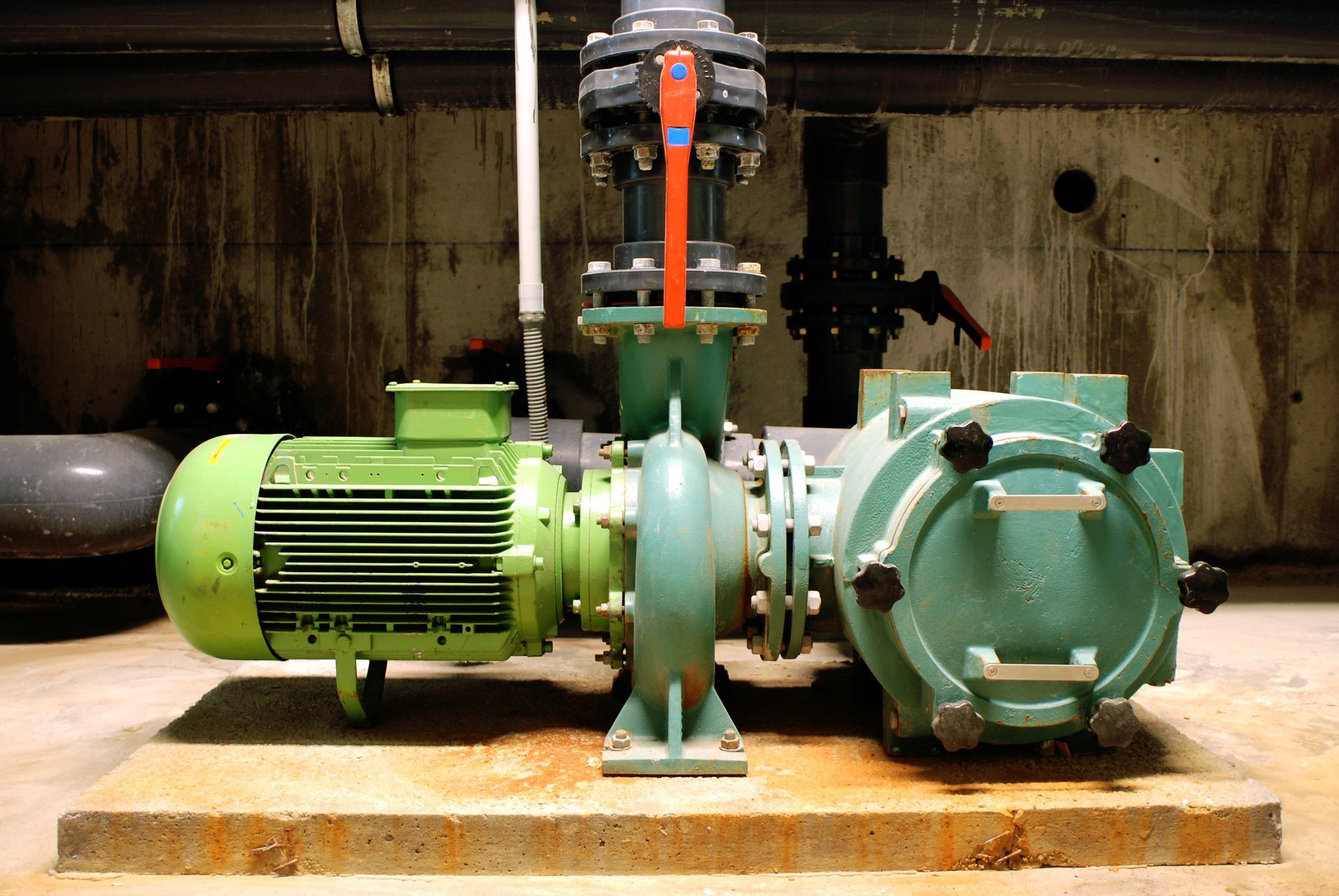 A green pump with a motor attached to it