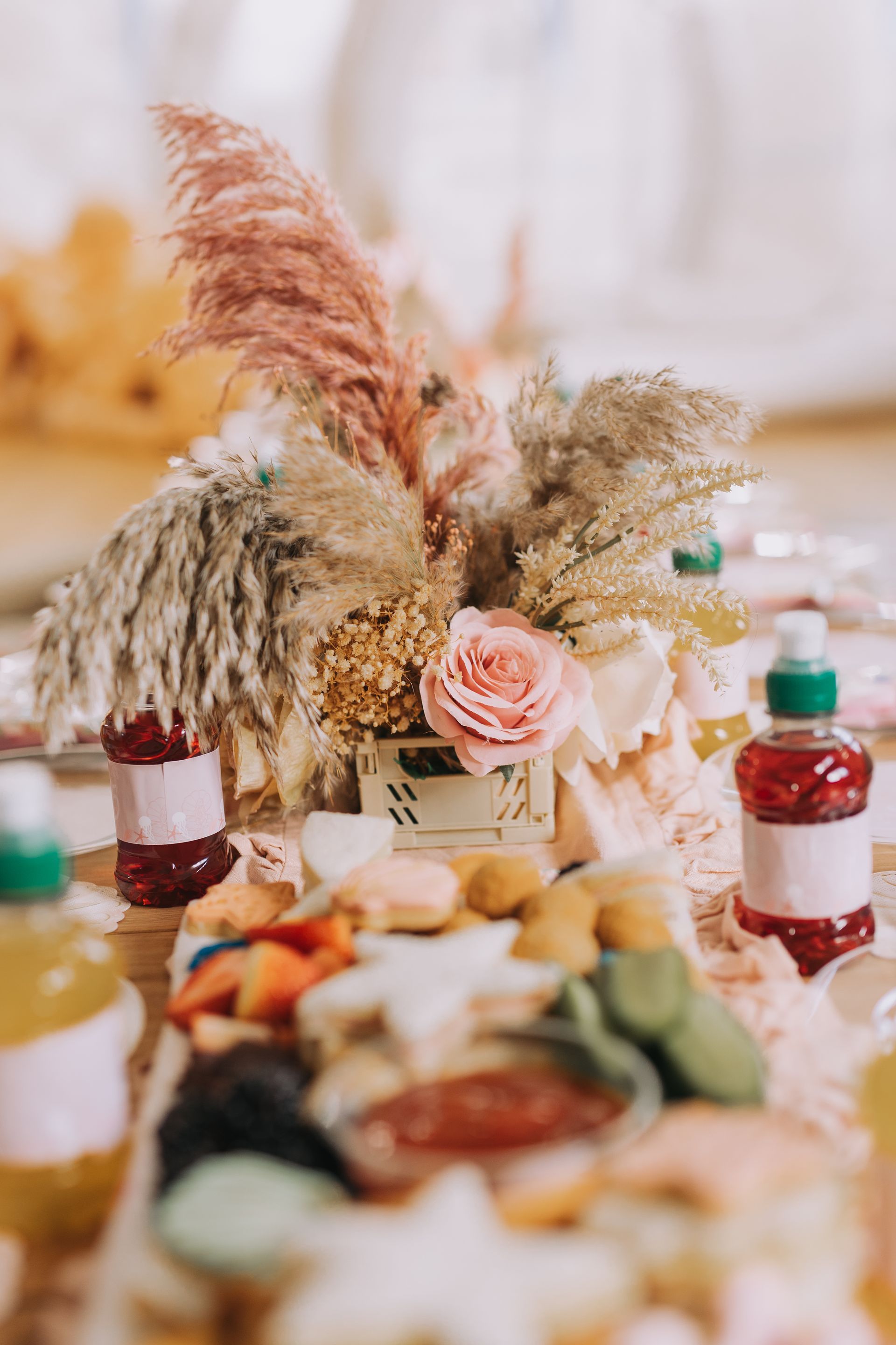 A table topped with a variety of food and flowers.