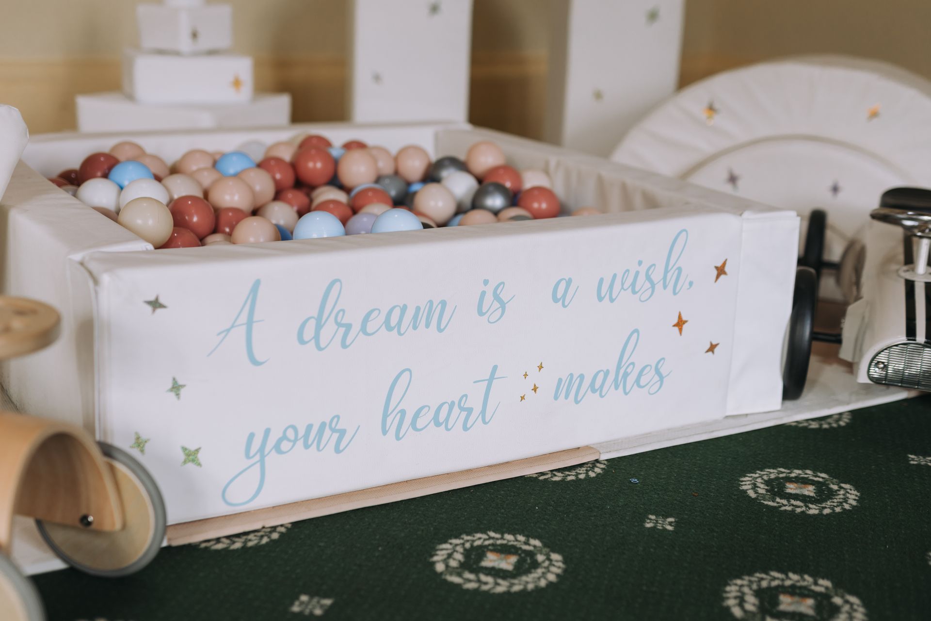 A ball pit filled with balls and a sign that says `` a dream is a wish your heart makes ''.